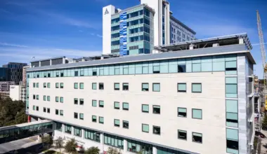 A modern building is pictured against a blue sky.