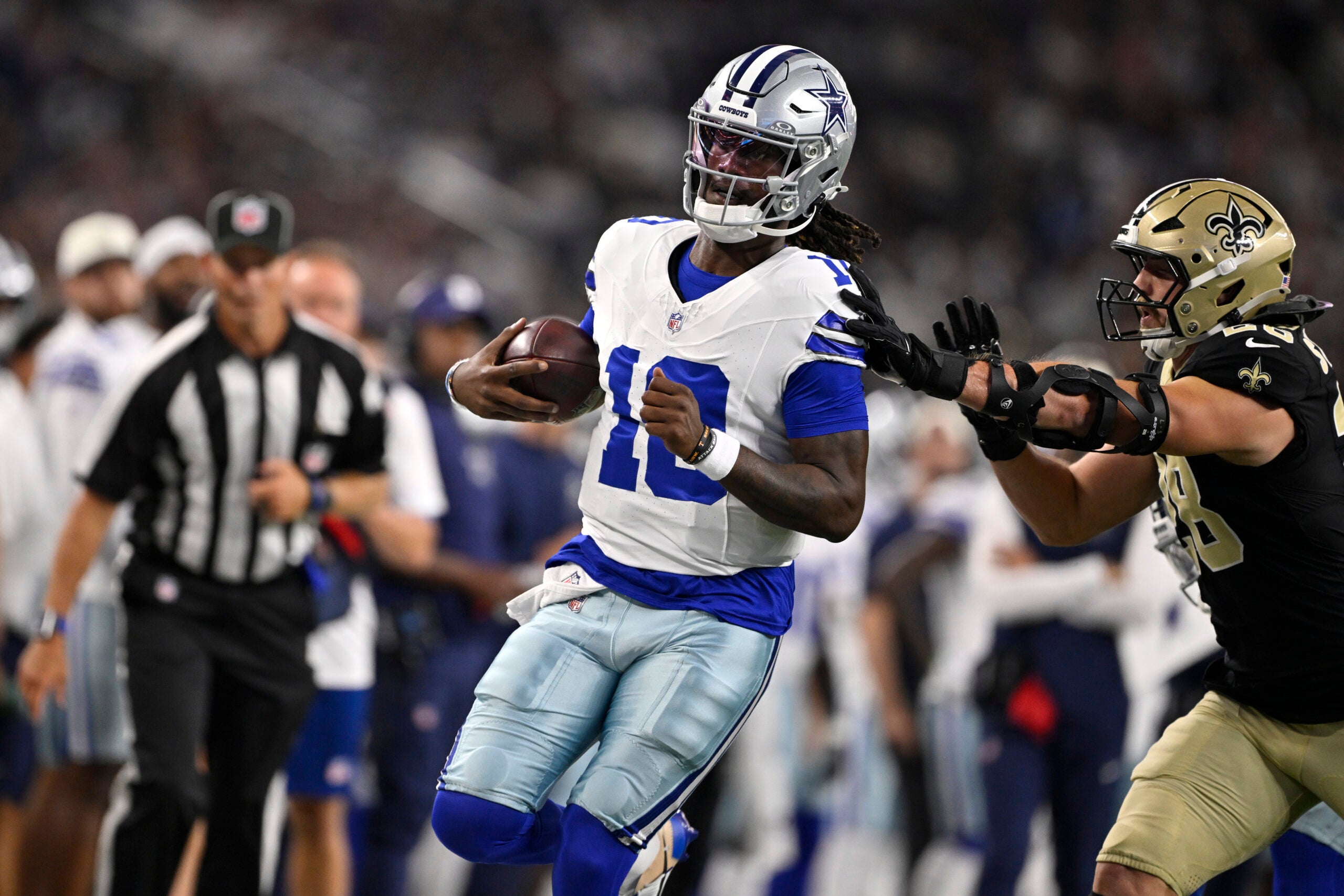 Aug 28, 2026; Arlington, Texas, USA; Dallas Cowboys quarterback Joe Milton III (10) is pushed out of bounds by New Orleans Saints linebacker Danny Stutsman (28) in the first quarter at AT&T Stadium.