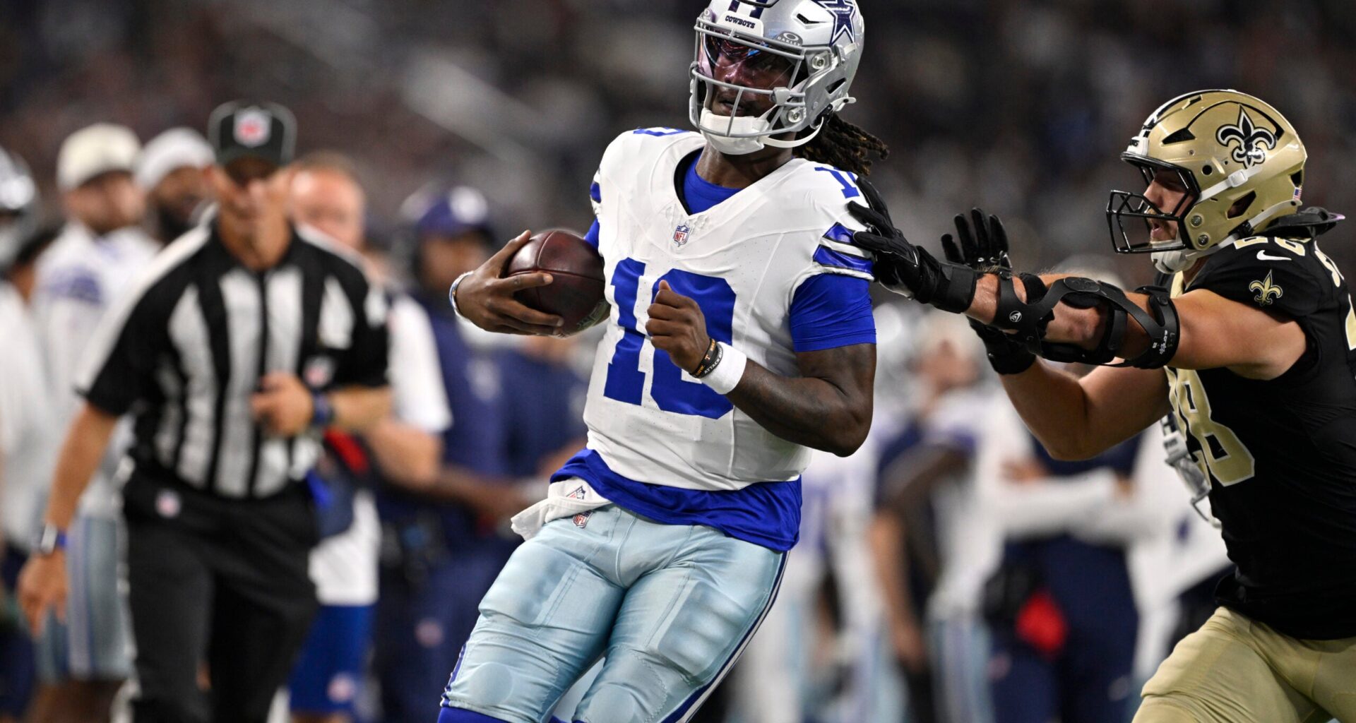 Aug 28, 2026; Arlington, Texas, USA; Dallas Cowboys quarterback Joe Milton III (10) is pushed out of bounds by New Orleans Saints linebacker Danny Stutsman (28) in the first quarter at AT&T Stadium.