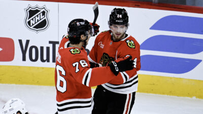 Sep 21, 2026; Chicago, Illinois, USA; Chicago Blackhawks defenseman Bowen Byram (24) celebrates with left wing Nick Lardis (76) after he scored the game winning goal during the overtime period against the Minnesota Wild at the United Center.