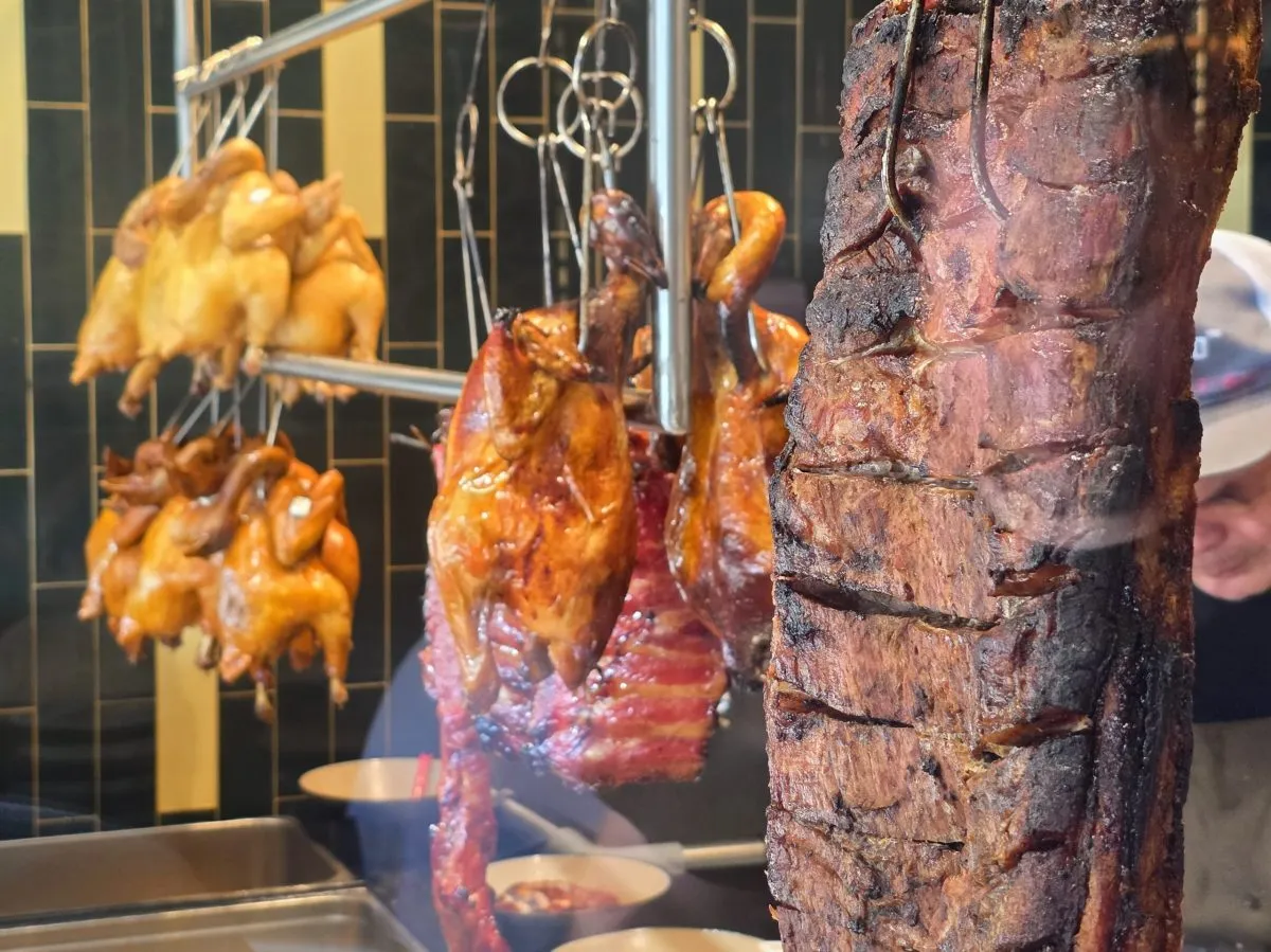 Roast fowl and ribs hang in the window at One Roast. Photo by Mario-Sebastian Berry.