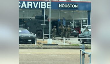 Houston SWAT, HPD serve warrant at used car dealership near Webster