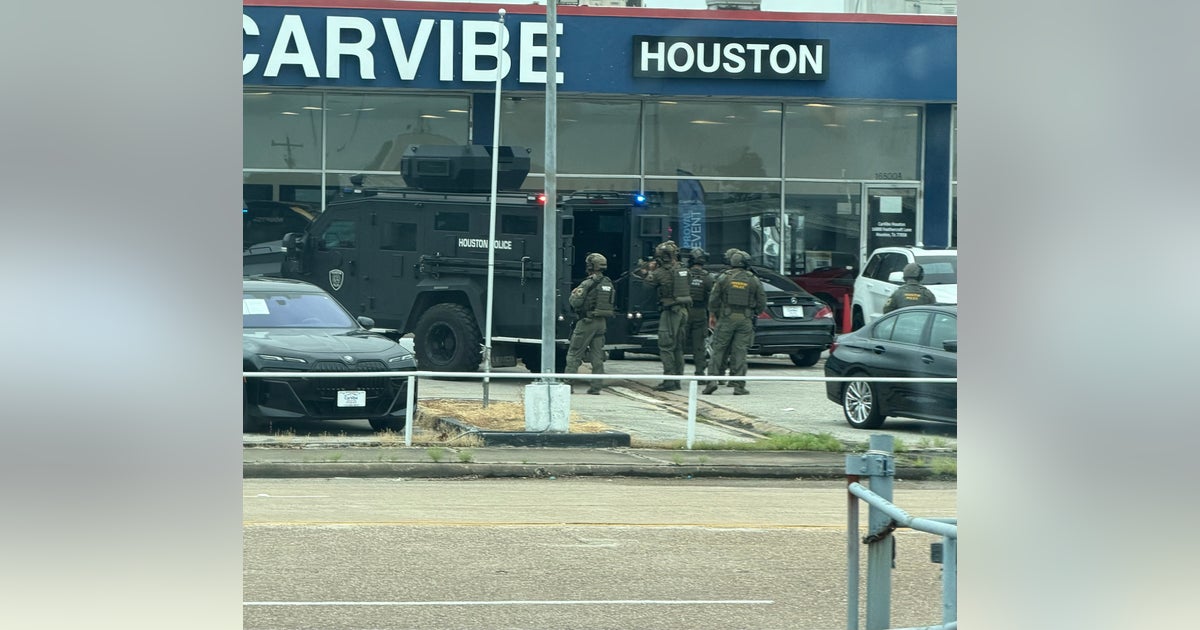 Houston SWAT, HPD serve warrant at used car dealership near Webster