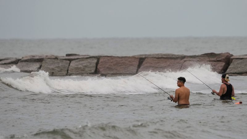 Fishermen cast their lines in surf stirred up by Tropical Storm Edouard in Galveston, Texas, Tuesday, Sept. 1, 2026. (Brett Coomer/Houston Chronicle via AP)
