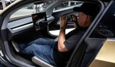 A man takes a photo inside a Tesla's "Cybercab" as it's displayed in downtown Austin, Texas, on September 3, 2026. Tesla is launching the "Cybercab" which is a taxi with no steering wheel or pedals, designed purely for autonomy. — AFP