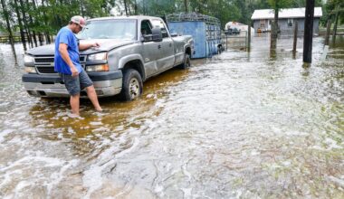 Chase Barfield walks to his truck as he takes belongings and his dogs away from floodwaters around his house in the aftermath of Tropical Storm Edouard near Honey Island, Texas, on Sept. 2, 2026.