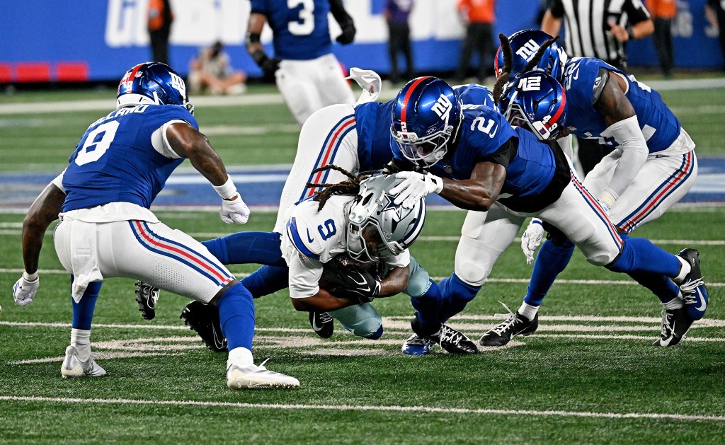 Dallas Cowboys wide receiver Kavontae Turpin is tackled by New York Giants cornerback Deonte Banks.