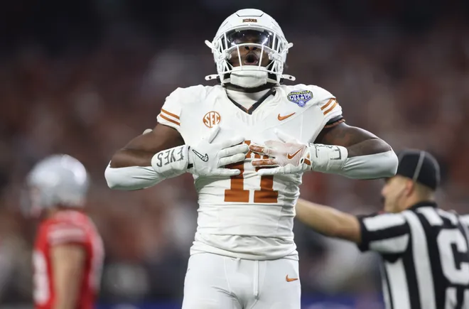 Jan 10, 2025; Arlington, Texas, USA; Texas Longhorns linebacker Colin Simmons (11) celebrates after a pass break up during the third quarter of the College Football Playoff semifinal against the Ohio State Buckeyes in the Cotton Bowl at AT & T Stadium. Mandatory Credit: Tim Heitman-Imagn Images