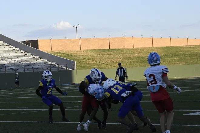 Three Legacy defenders make a tackle during a homecoming game between the Leopards and Lubbock Monterey on Friday, Sept. 11, 2026.
