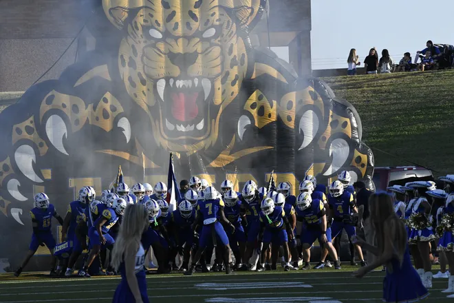 Legacy football runs out of its tunnel before the Leopards' homecoming game against Lubbock Monterey on Friday, Sept. 11, 2026.