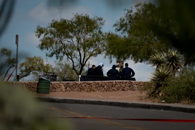 El Paso police officers gather behind a crime scene barrier while investigating a shooting at Tom Lea Park in West El Paso on Saturday, Sept. 12, 2026.