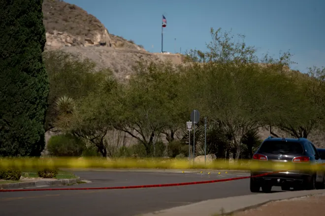 Evidence markers line a road cordoned off with police tape during an investigation into a shooting at Tom Lea Park in West El Paso on Saturday, Sept. 12, 2026.