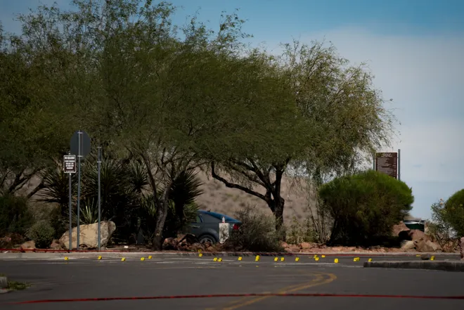 Evidence markers line a road cordoned off with police tape during an investigation into a shooting at Tom Lea Park in West El Paso on Saturday, Sept. 12, 2026.