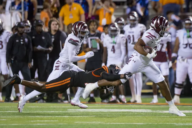 Texas Southern’s Jacob Washington runs with the ball as UTEP’s Esteban Guillory attempts a tackle during a football game Saturday, Sept. 12, 2026, at Sun Bowl Stadium in El Paso, Texas.