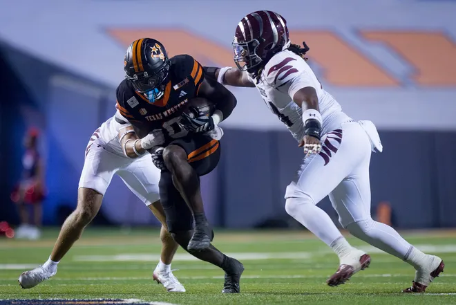 UTEP’s Tavorus Jones runs with the ball as Texas Southern defenders attempt to tackle him during the football home opener Saturday, Sept. 12, 2026, at Sun Bowl Stadium in El Paso, Texas.