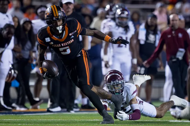 UTEP’s Carver Cheeks runs past a Texas Southern defender during the football home opener Saturday, Sept. 12, 2026, at Sun Bowl Stadium in El Paso, Texas.