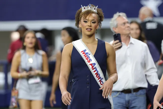Sep 20, 2026; Arlington, Texas, USA; 2027 Miss America Regan Hutsell walks on the field before a game between the Washington Commanders and the Dallas Cowboys at AT & T Stadium. Mandatory Credit: Kevin Jairaj-Imagn Images