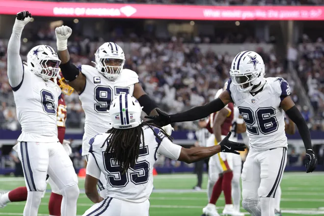 Sep 20, 2026; Arlington, Texas, USA; Dallas Cowboys linebackers Jaishawn Barham (55) and Donovan Ezeiruaku (6) celebrate with defensive tackle Kenny Clark (97) and cornerback DaRon Bland (26) after a defensive play against the Washington Commanders during the first half at AT & T Stadium. Mandatory Credit: Kevin Jairaj-Imagn Images