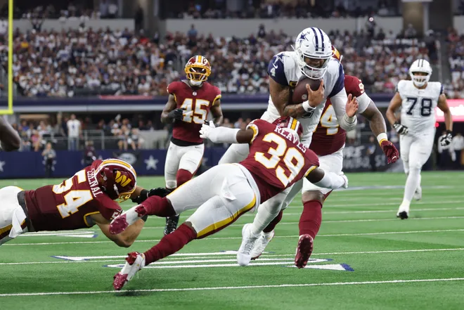 Sep 20, 2026; Arlington, Texas, USA; Dallas Cowboys quarterback Dak Prescott (4) runs the ball against Washington Commanders safety Jeremy Reaves (39) and linebacker Leo Chenal (54) during the first quarter at AT & T Stadium. Mandatory Credit: Kevin Jairaj-Imagn Images