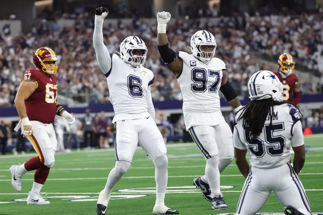 Sep 20, 2026; Arlington, Texas, USA; Dallas Cowboys linebackers Jaishawn Barham (55) and Donovan Ezeiruaku (6) celebrate with defensive tackle Kenny Clark (97) after a defensive play against the Washington Commanders during the first half at AT & T Stadium. Mandatory Credit: Kevin Jairaj-Imagn Images