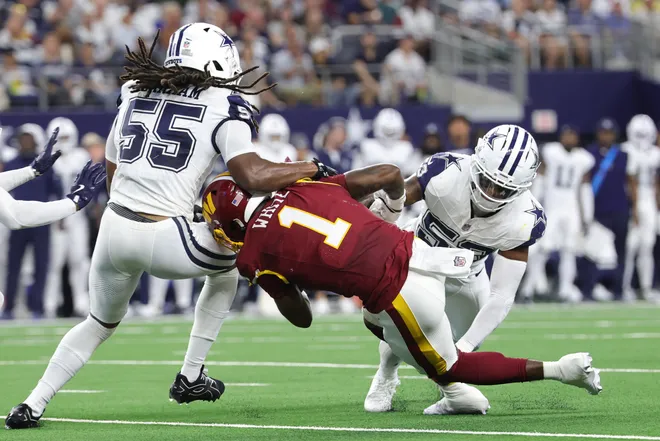 Sep 20, 2026; Arlington, Texas, USA; Washington Commanders running back Rachaad White (1) is tackled by Dallas Cowboys linebackers Jaishawn Barham (55) and Dee Winters (53) during the first half at AT & T Stadium. Mandatory Credit: Kevin Jairaj-Imagn Images