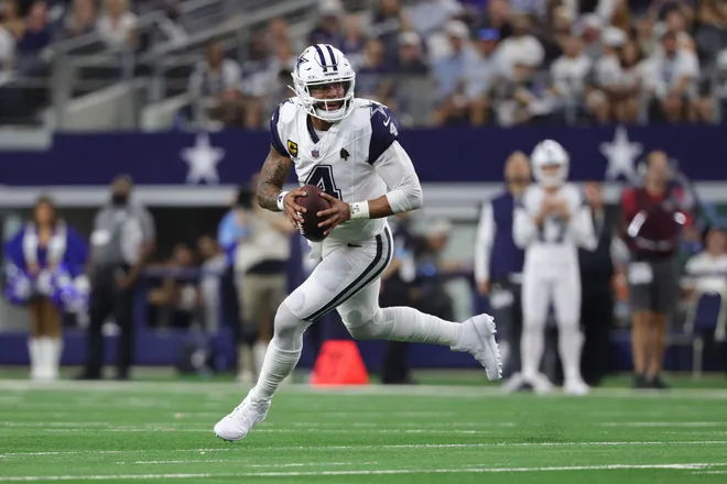Sep 20, 2026; Arlington, Texas, USA; Dallas Cowboys quarterback Dak Prescott (4) scrambles against the Washington Commanders defense during the first half at AT & T Stadium. Mandatory Credit: Kevin Jairaj-Imagn Images