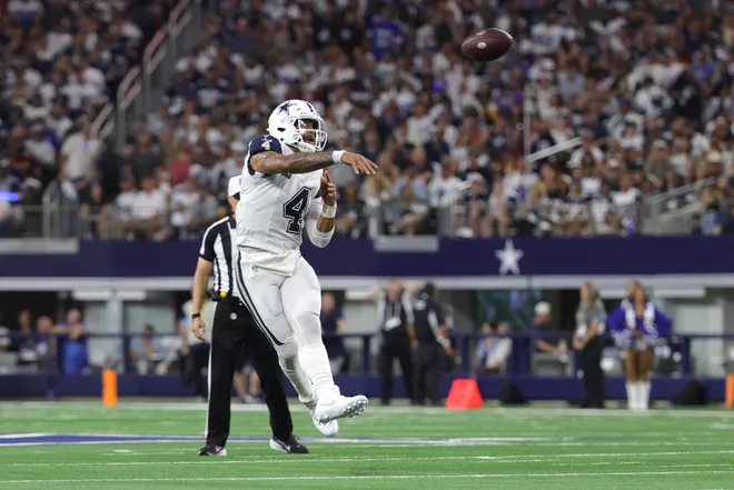 Sep 20, 2026; Arlington, Texas, USA; Dallas Cowboys quarterback Dak Prescott (4) leaps to throw a pass against the Washington Commanders defense during the first half at AT & T Stadium. Mandatory Credit: Kevin Jairaj-Imagn Images