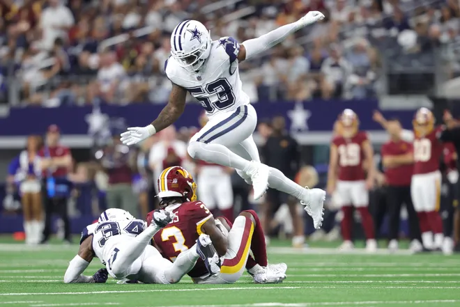 Sep 20, 2026; Arlington, Texas, USA; Dallas Cowboys linebacker Dee Winters (53) leaps over safety Jalen Thompson (34) and Washington Commanders wide receiver Stefon Diggs (3) during the second half at AT & T Stadium. Mandatory Credit: Kevin Jairaj-Imagn Images