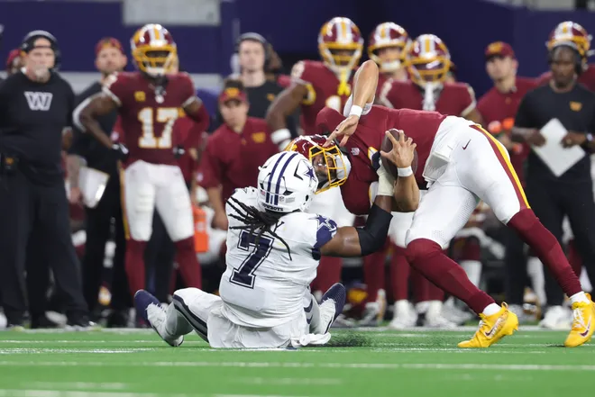 Sep 20, 2026; Arlington, Texas, USA; Dallas Cowboys linebacker Rashan Gary (7) tackles Washington Commanders quarterback Marcus Mariota (8) along the sideline during the second half at AT & T Stadium. Mandatory Credit: Kevin Jairaj-Imagn Images