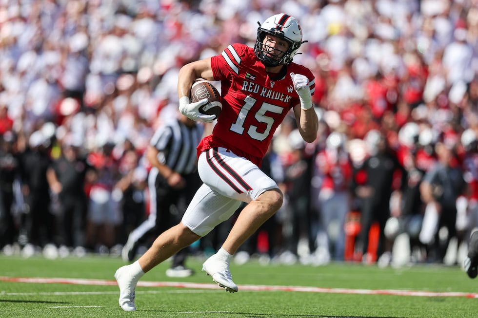 Texas Tech linebacker Austin Romaine (15) returns an interception for a touchdown during the...