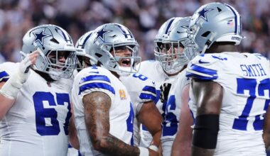 Dallas Cowboys' Dak Prescott, second from left, celebrates with Brock Hoffman (67), Tyler Smith (73) and others after running the ball for a touchdown in the first half of an NFL football game against the Green Bay Packers Sunday, Sept. 28, 2025, in Arlington, Texas. (AP Photo/Julio Cortez)