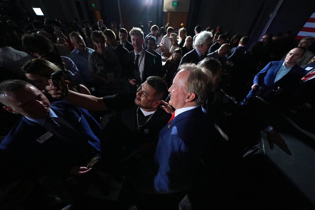 Texas Attorney General Ken Paxton, a Republican candidate for the U.S. Senate, poses for a selfie with a supporter during a primary election night watch party Tuesday, March 3, 2026, in Dallas. (AP Photo/Julio Cortez)
