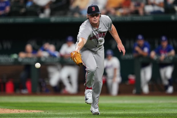 Boston Red Sox pitcher Jake Bennett attempts to reach an infield single by Texas Rangers' Danny Jansen in the fourth inning of a baseball game Wednesday, Sept. 16, 2026, in Arlington, Texas. (AP Photo/Tony Gutierrez)