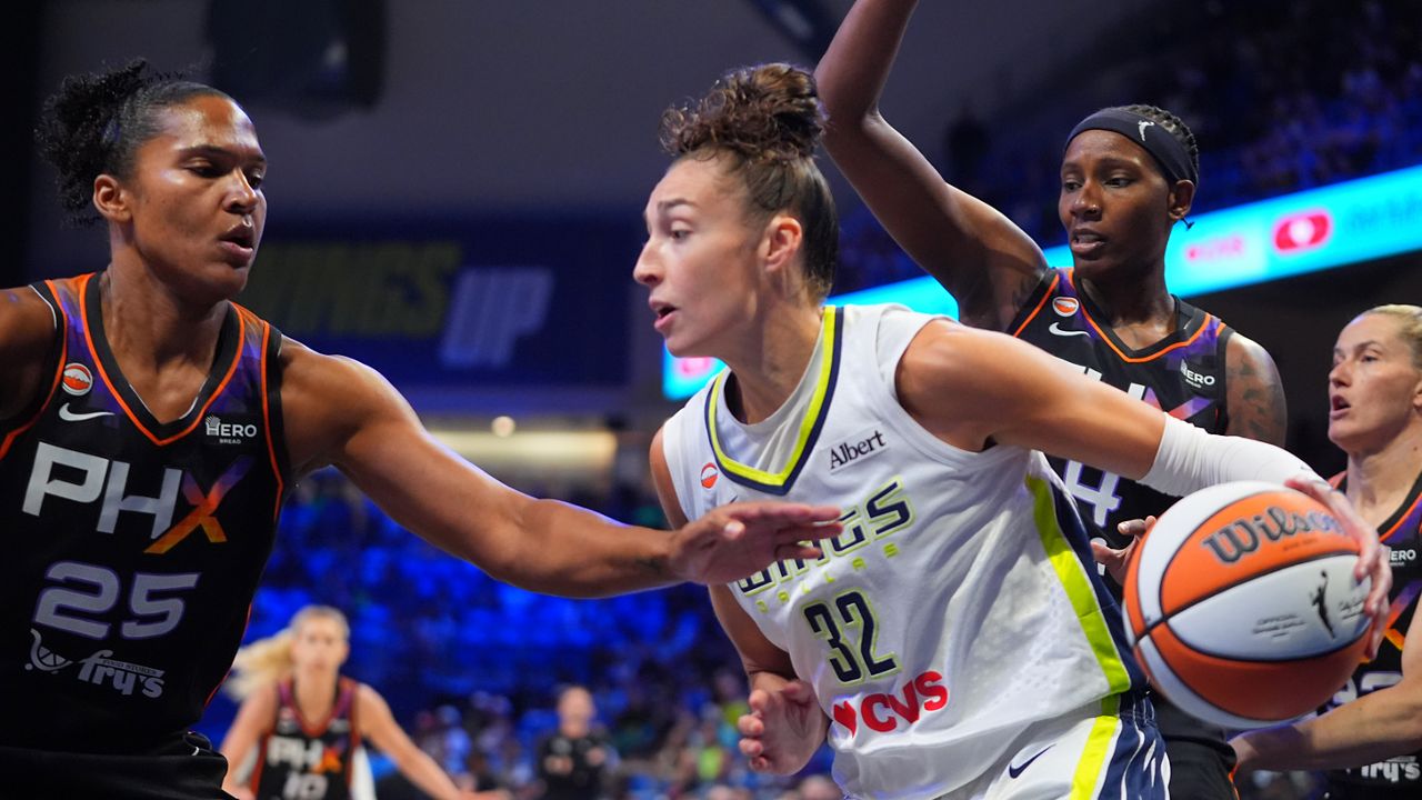 Dallas Wings forward Jessica Shepard (32) drives against Phoenix Mercury defenders Alyssa Thomas (25) and Natasha Mack (4) during the first half of a WNBA basketball game in Arlington, Texas, Saturday, Sept. 19, 2026. (AP Photo/LM Otero)