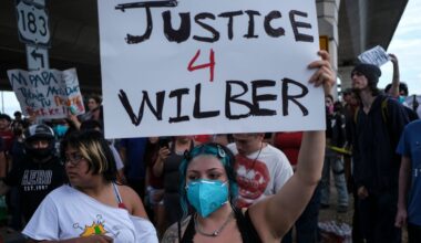 People speak during a demonstration where a man was shot in his vehicle by an ICE officer, Sunday, Sept. 20, 2026, in Austin, Texas. (AP Photo/Joel Angel Juarez)