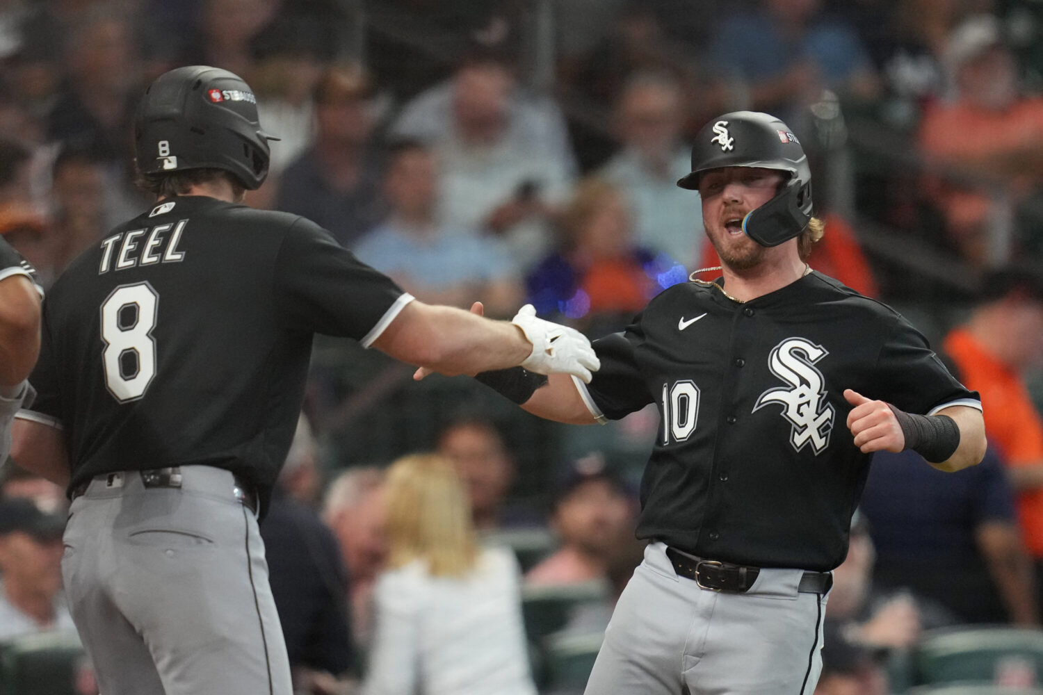 Chicago White Sox's Chase Meidroth (10) celebrates with Kyle Teel (8) after scoring off a 2-run single hit by by Sam Antonacci during the second inning in Game 1 of baseball's American League Wild Card Series against the Houston Astros, Tuesday, Sept. 29, 2026, in Houston.