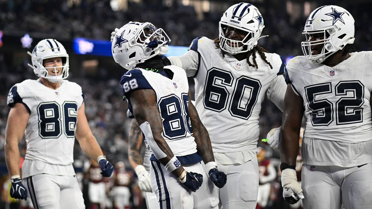 Dallas Cowboys wide receiver Ceedee Lamb (88) celebrates with offensive tackle Tyler Guyton (60) and guard Tyler Booker (52) after scoring a touchdown against the Washington Commanders in the second half during an NFL football game in Arlington, Texas, Sunday, Sept. 20, 2026. (AP Photo/Jessica Tobias)