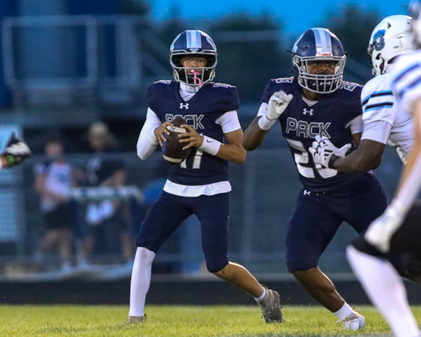 Oswego East's Carter Meindel (17) surveys the field during football game between Willowbrook at Oswego East. Friday, August 28, 2026 in Oswego.
