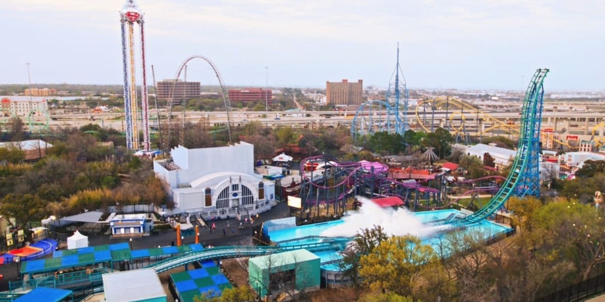 Six Flags Over Texas theme park in Arlington, Texas, with roller coasters visible behind the park’s Six Flags branding.