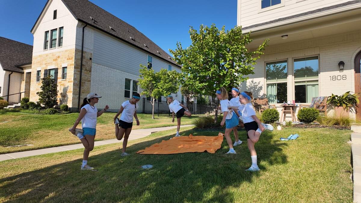 11-year-old Delaila Lamy (middle) leads her friends in stretches on Aug. 29, 2026 in Aledo for her Saturday morning Faith in Motion run club she started in honor of her father.