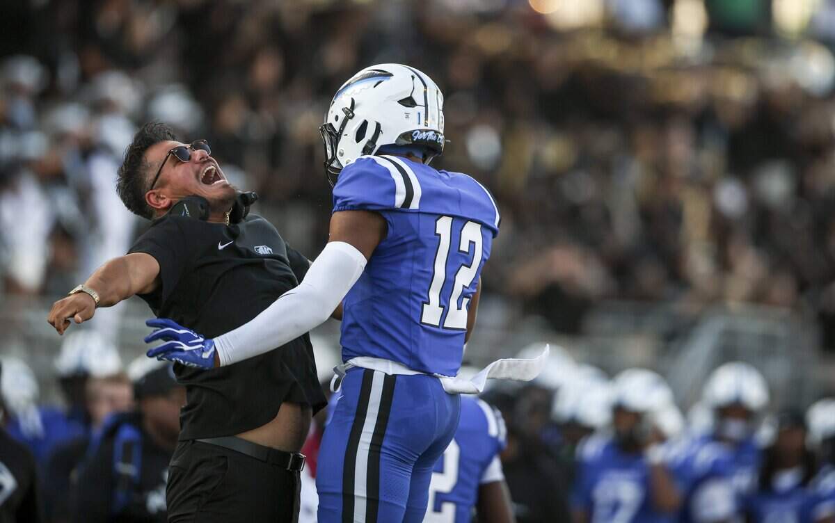 North Crowley wide receiver Kade Smith (12) celebrates scoring a touchdown with his coach against Southlake Carroll during the first half of the game on Friday, Sept. 4, 2026 at Crowley ISD Stadium in Fort Worth.