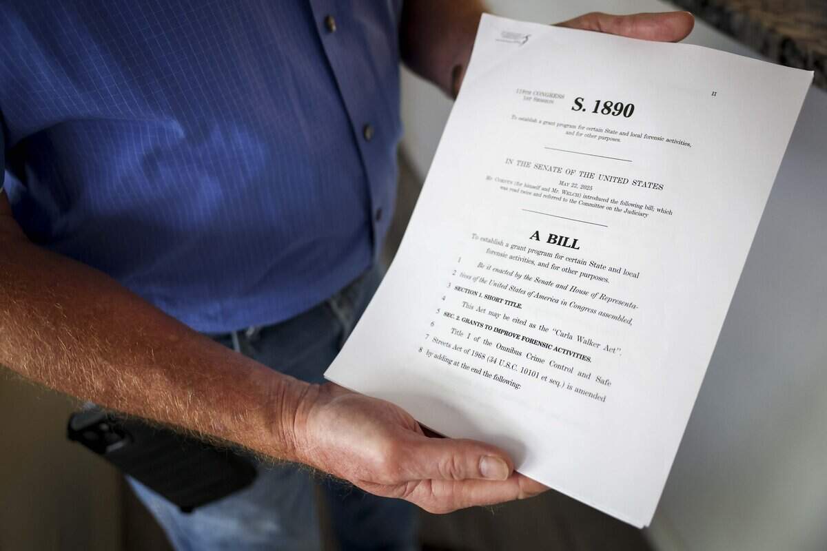 Jim Walker, brother of Fort Worth cold case victim Carla Walker, holds a copy of the Carla Walker Act on Tuesday, July 7, 2026 in Fort Worth. The legislation would establish funding for the use of Forensic Genetic Genealogy DNA analysis to solve unsolved crimes and identify human remains.