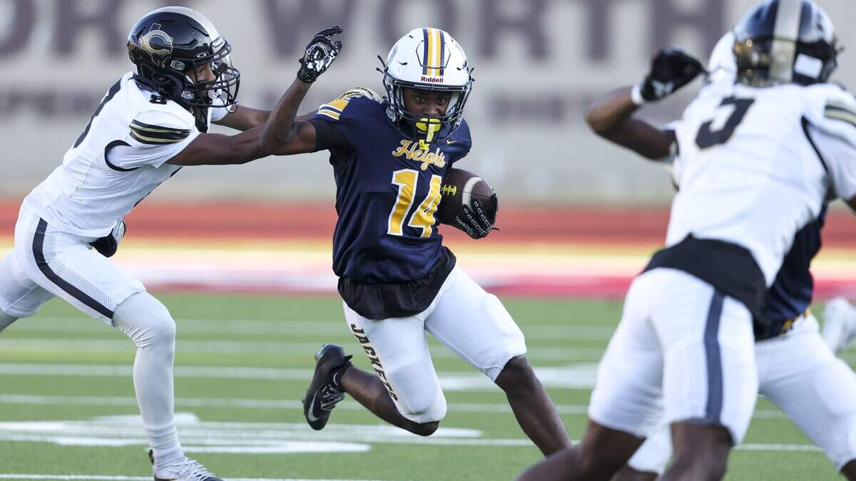 Arlington Heights running back Jaquan Evans (14) runs the ball during the game against Cleburne on Thursday, Sept. 3, 2026 at Farrington Field in Fort Worth.