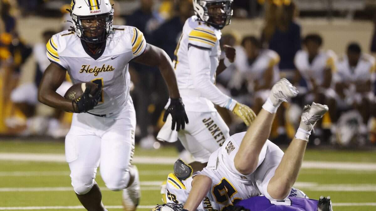 Arlington Heights running back Carson James (1) carries the ball out of the backfield during the first half of a UIL football game between Arlington Heights and Paschal at Farrington Field in Fort Worth, Texas, Friday Nov. 07, 2025.