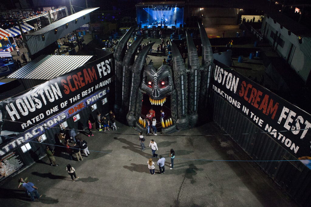 Image shows the entrance to Scream Fest in Houston featuring a giant, gaping mouth of a monster figure.