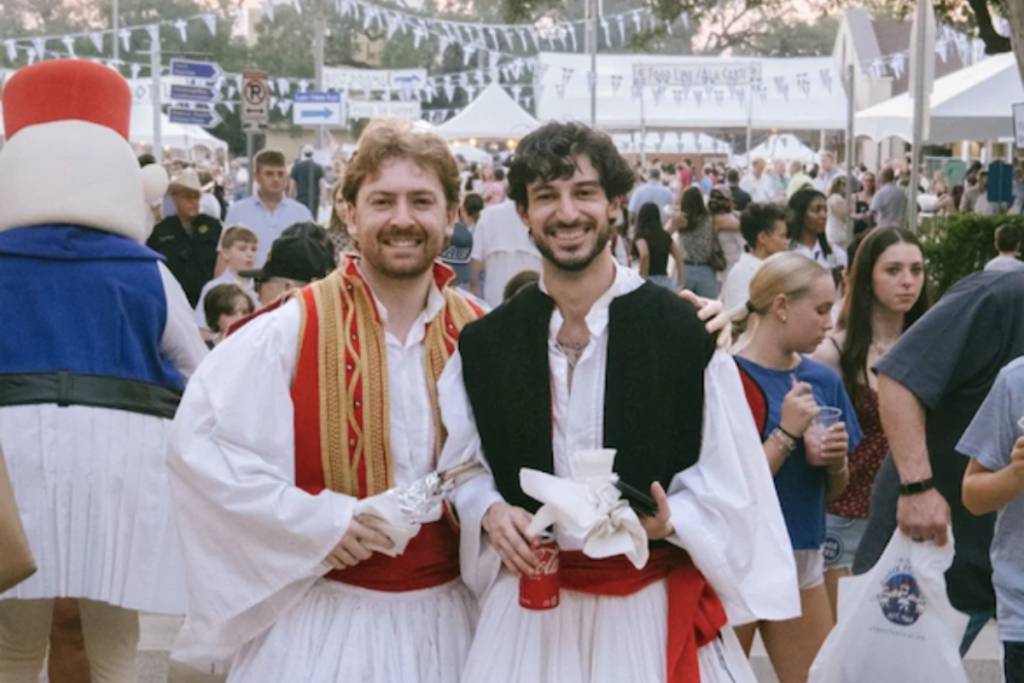 Image shows two festival-goers posing for a photo at the Original Greek Festival in Houston. 
