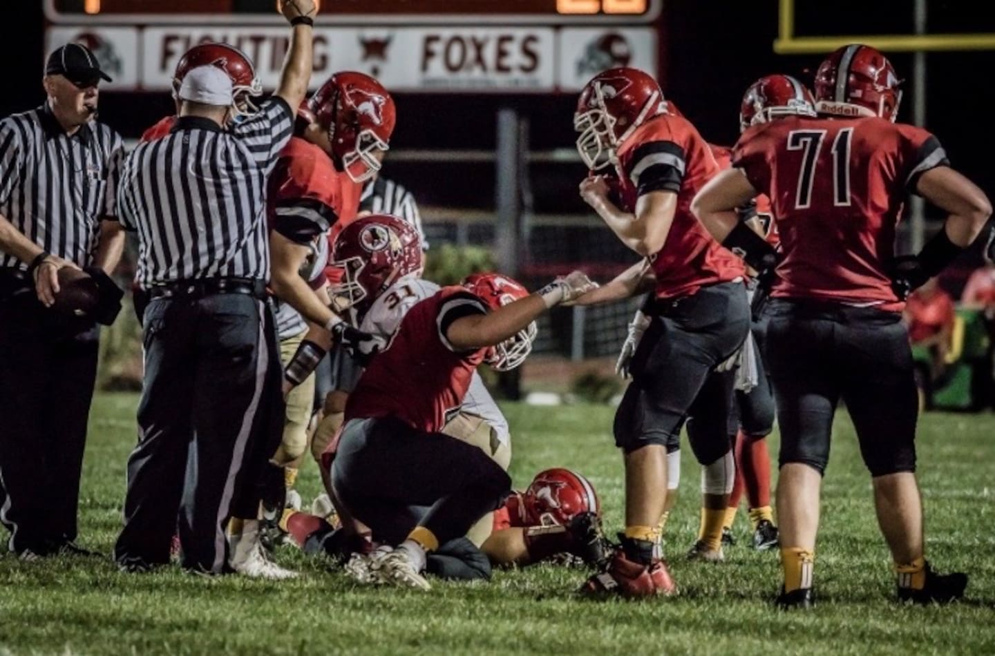 Yorkville's Philip LoChirco (right) helps up teammate Chris Galloway during a football game between Yorkville and Oswego on Sept. 22, 2017, in Yorkville.