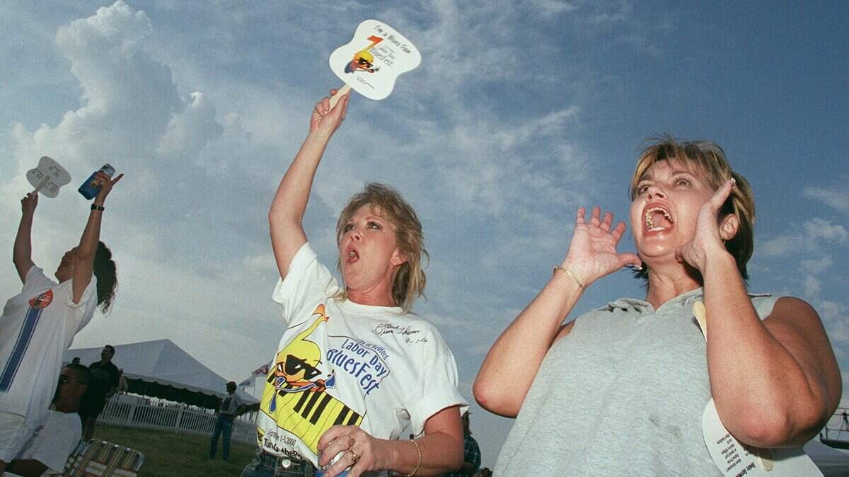 Sept. 2, 2000: Sue Lucas (right) of Euless and her friend Lindy Anderson of Grand Praire cheer for Morris Price Band at the city of Bedford Labor Day Bluesfest.
