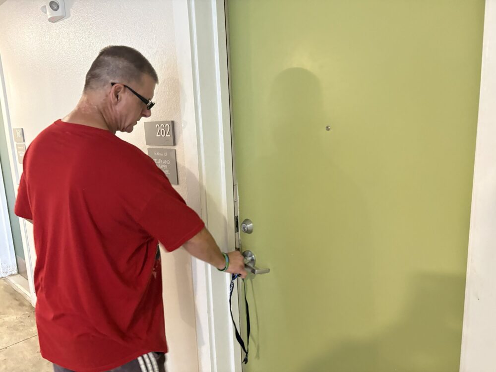 Thomas Romero opens the door of his apartment at a New Hope Housing complex in Houston.