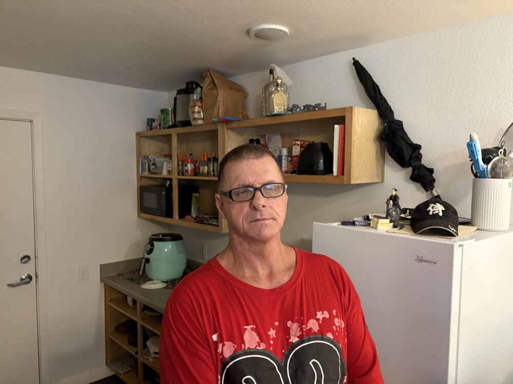 Thomas Romero stands in his rent-free studio unit at a nonprofit apartment complex operated by New Hope Housing in Houston.